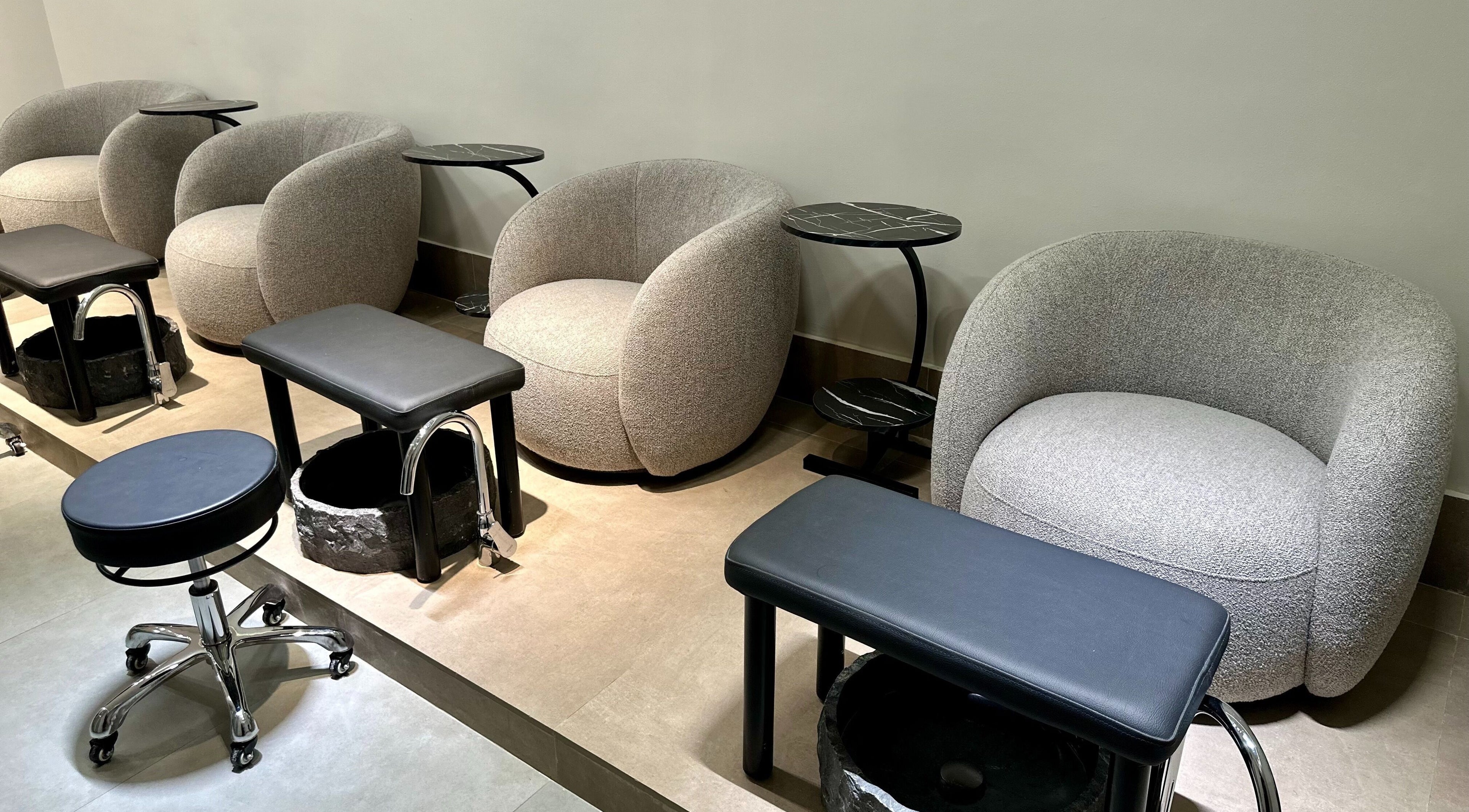 Stylish nail care stations at Al Maali Beauty Lounge, Dubai, Dubai, AE, featuring plush seating and modern design.