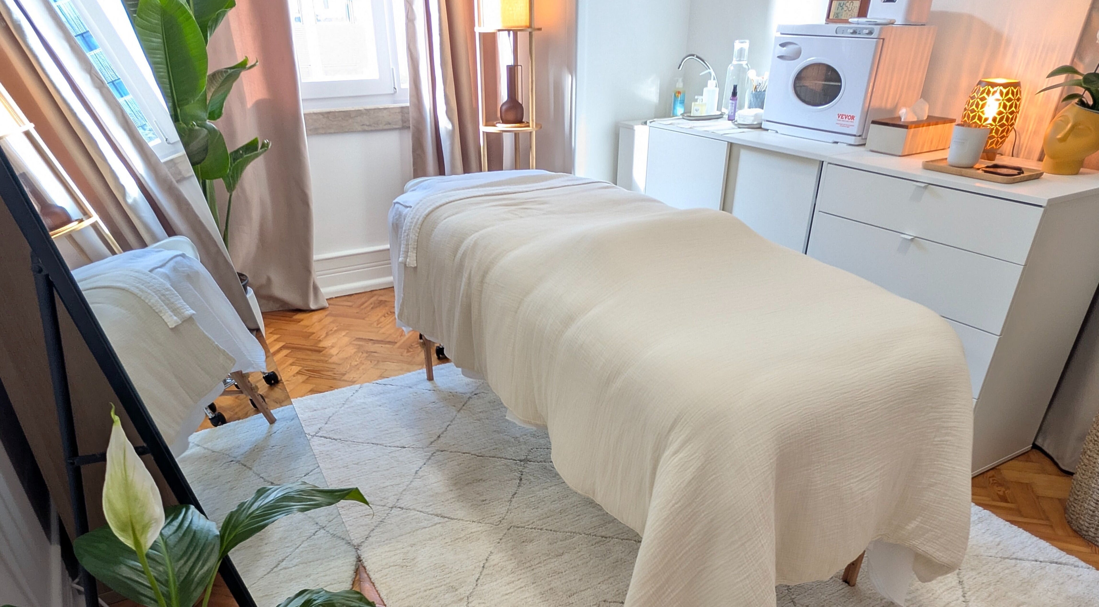 Sala de tratamento tranquila em Daniela Dos Santos, Lisboa, PT, com uma cama confortável e decorações suaves.