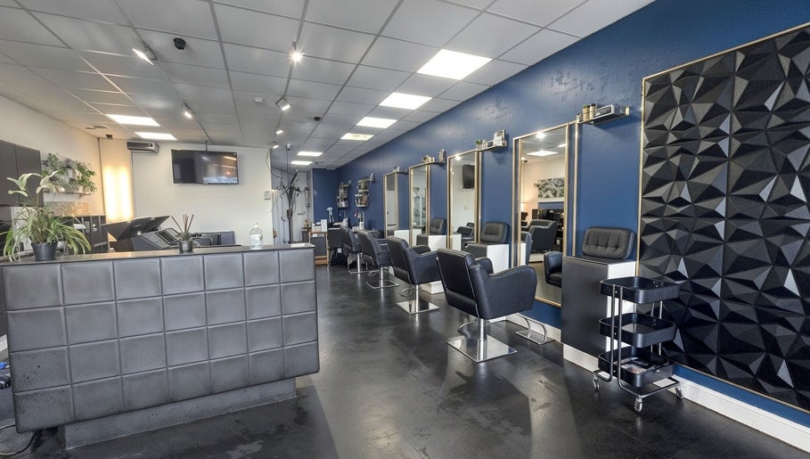 Stylish interior of Inhibition Hair & Beauty Salon in Telford, England, GB with elegant chairs and décor.