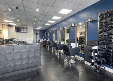 Stylish interior of Inhibition Hair & Beauty Salon in Telford, England, GB with elegant chairs and décor.