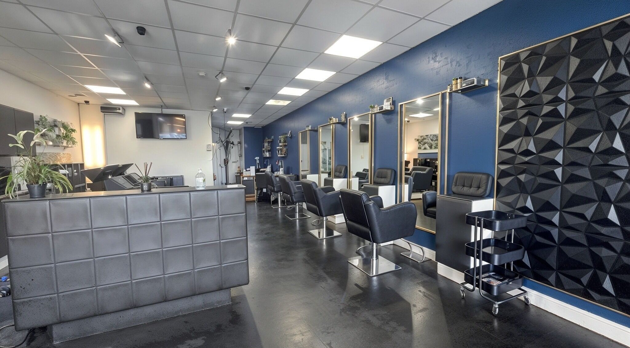 Stylish interior of Inhibition Hair & Beauty Salon in Telford, England, GB with elegant chairs and décor.