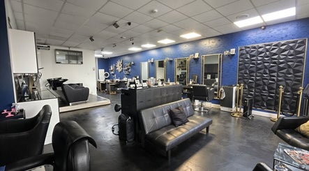 Elegant interior of Inhibition Hair & Beauty Salon, Telford, England, GB, featuring sleek black seating and mirrors.