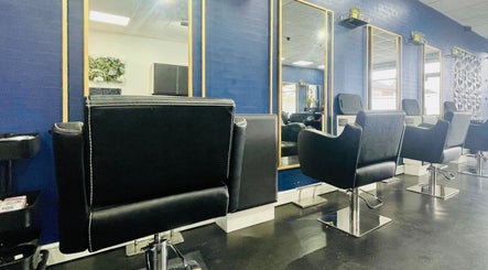 Elegant styling chairs in Inhibition Hair & Beauty Salon, Telford, England, GB with modern blue decor.