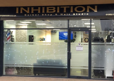 Front view of Inhibition Hair & Beauty Salon, Telford, England, GB, showcasing the stylish exterior design.