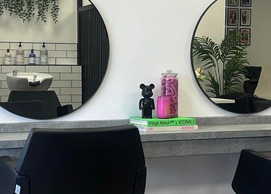 Modern salon interior at India Frances Makeup, Colwyn Bay, Wales, GB, with round mirrors and stylish decor.