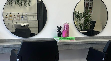 Modern salon interior at India Frances Makeup, Colwyn Bay, Wales, GB, with round mirrors and stylish decor.