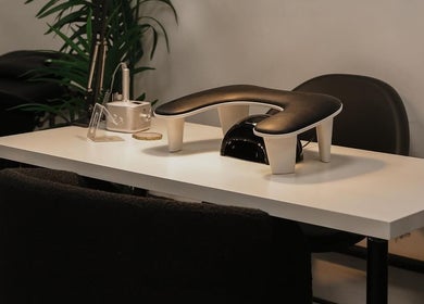 Modern nail station setup at India Frances Makeup, Colwyn Bay, Wales, GB, featuring sleek tools and greenery.