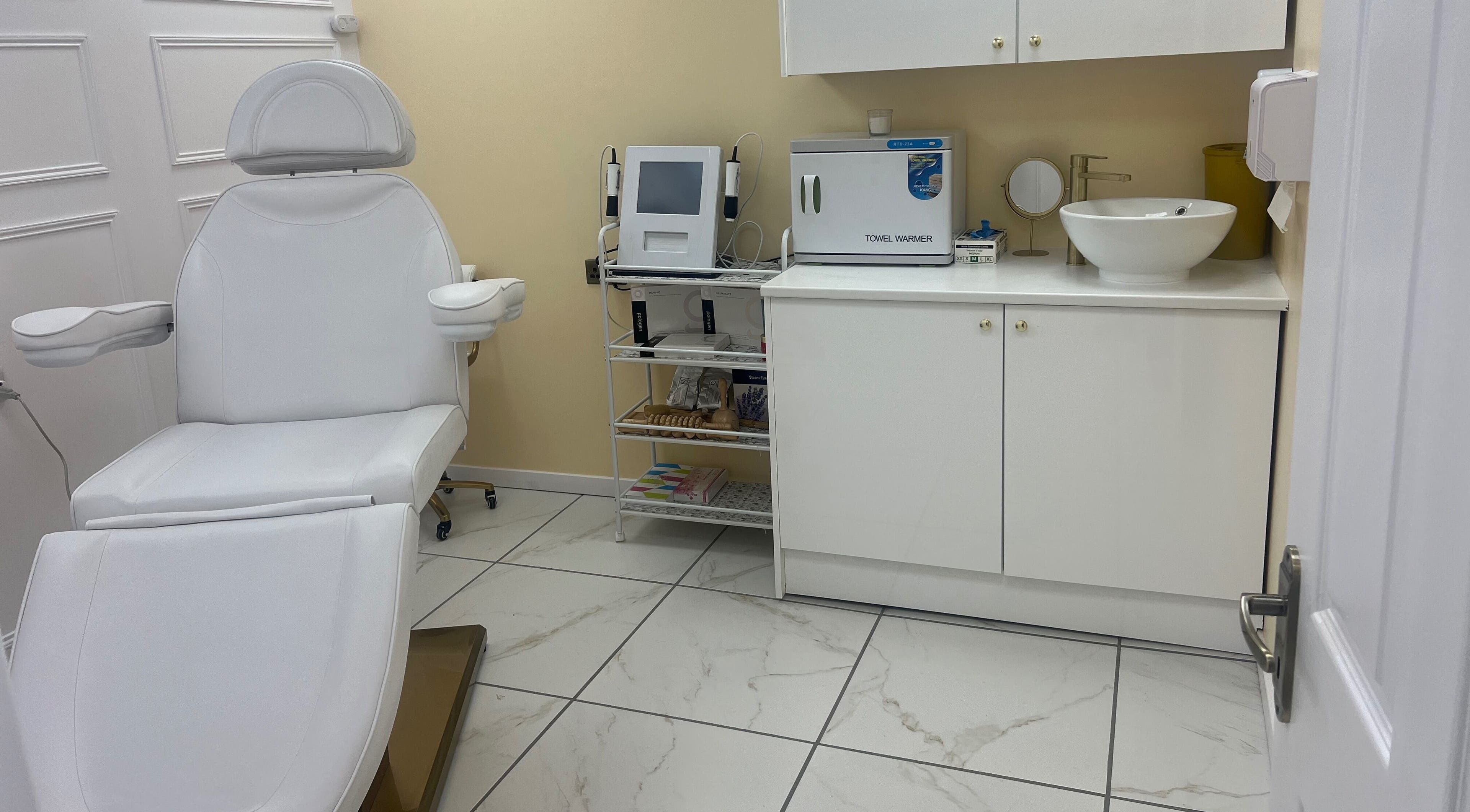 Modern treatment room at Mia Bella Beauty Salon, West End Glasgow, Scotland, GB with white chair and equipment.