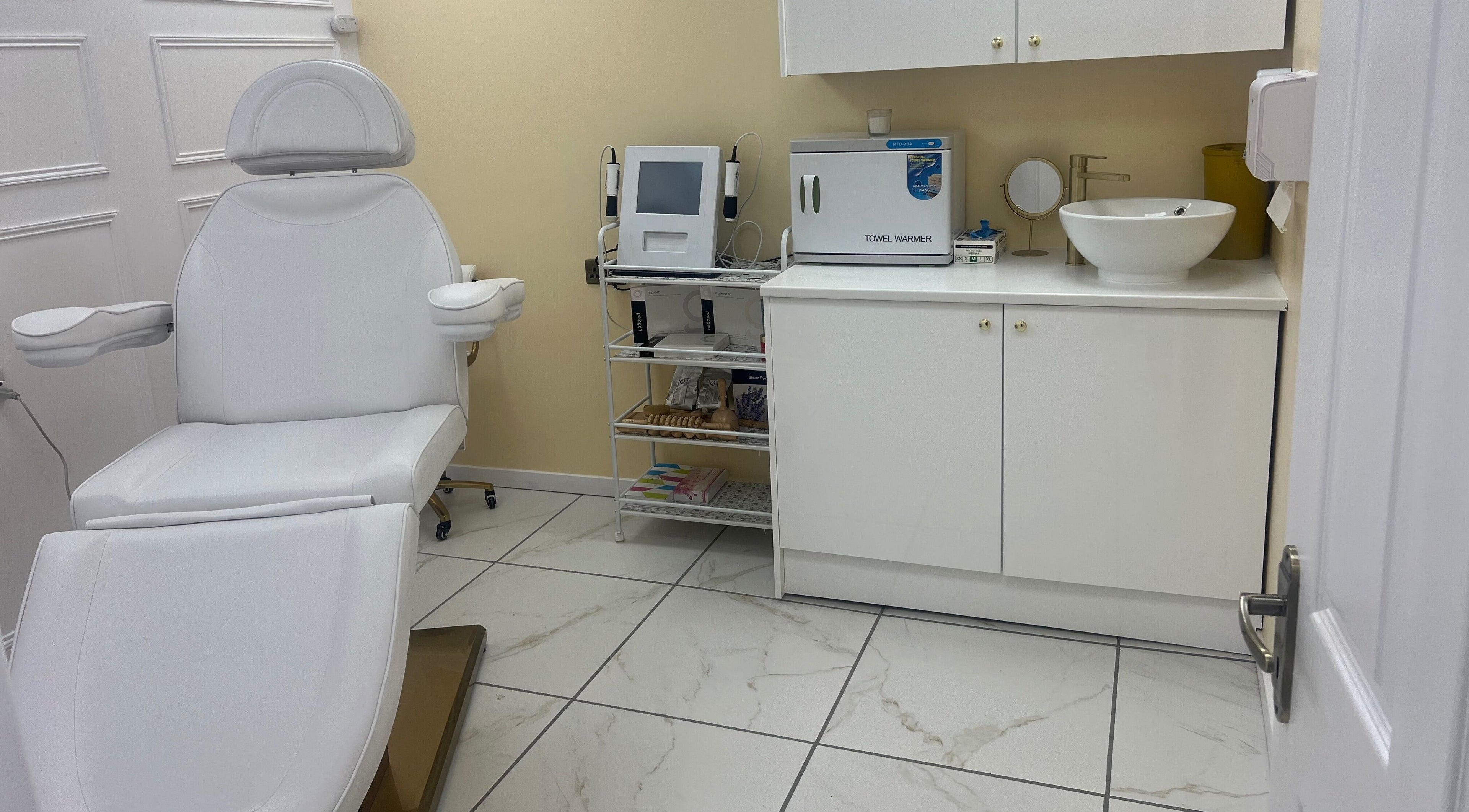 Modern treatment room at Mia Bella Beauty Salon, West End Glasgow, Scotland, GB with white chair and equipment.