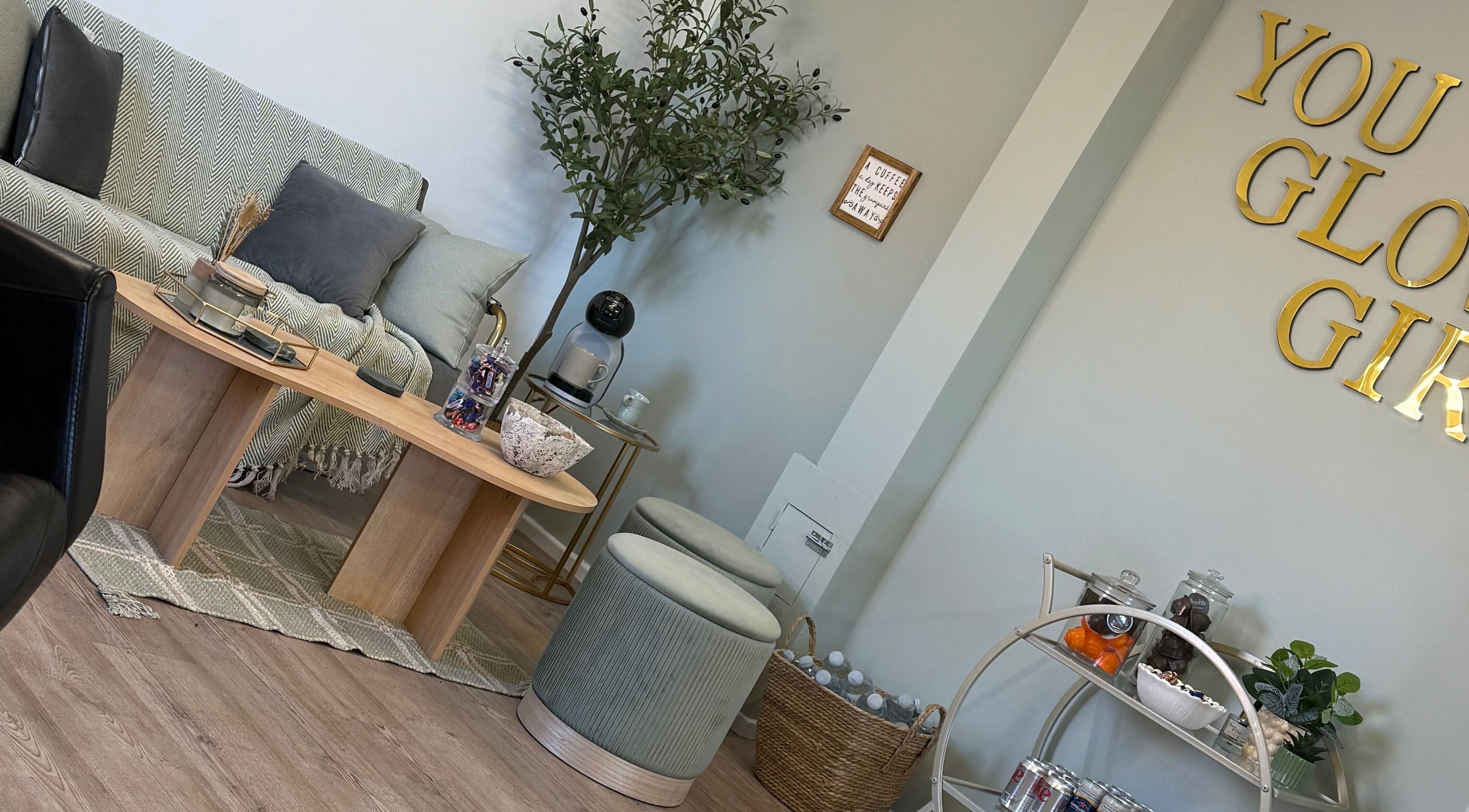 Cozy seating area in Lauren Cheetham Hair, Wigan, England, GB, with elegant decor and refreshments.
