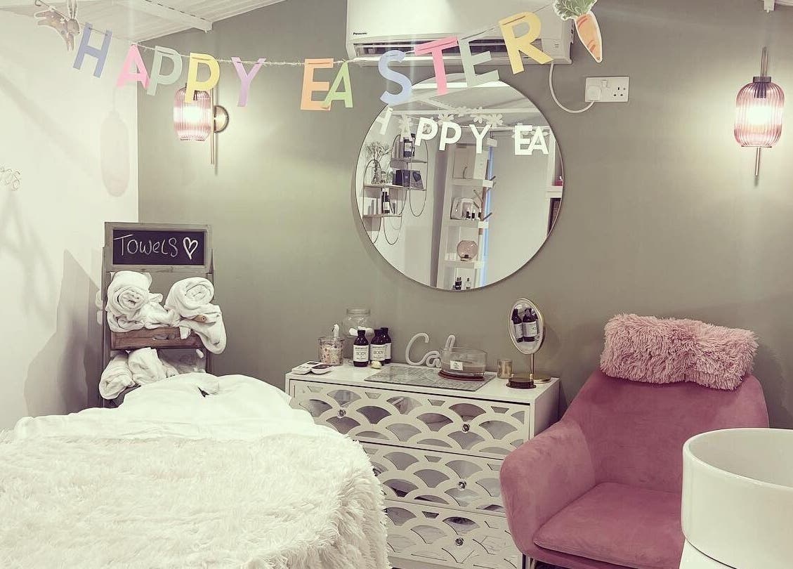 Cozy spa room at Beauty by Felicity in Addlestone, England, with Easter decor and plush seating.