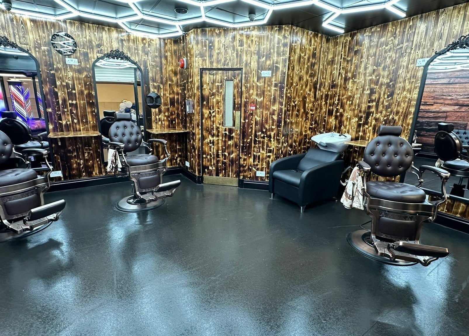 Elegant barber chairs and mirrors at Eldon Barbers in Newcastle upon Tyne, England, GB.
