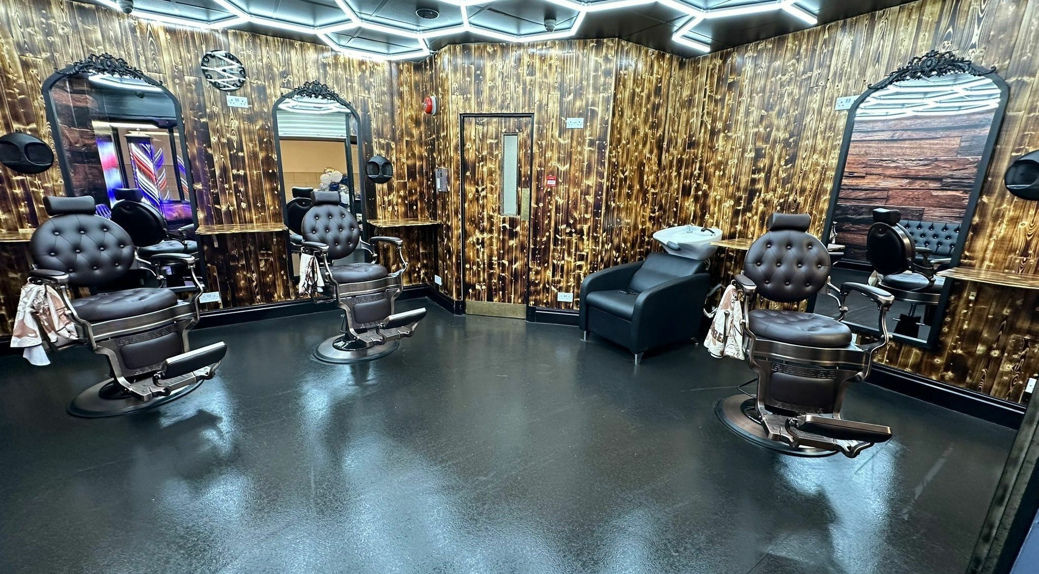 Elegant barber chairs and mirrors at Eldon Barbers in Newcastle upon Tyne, England, GB.