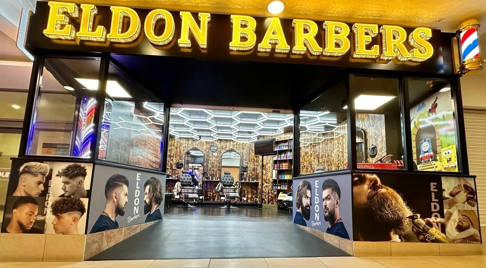 Eldon Barbers storefront with illuminated sign and modern interior in Newcastle upon Tyne, England, GB.