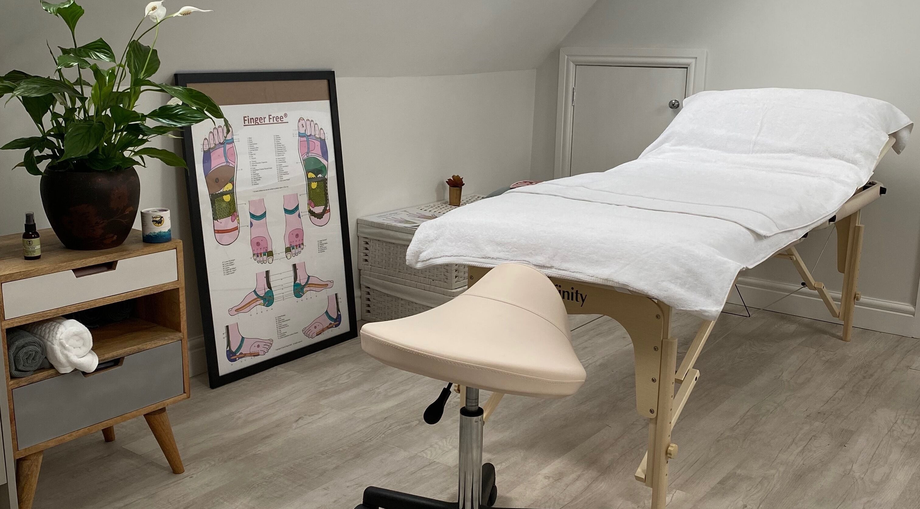 Relaxing treatment room at Carole Coram Reflexology, Buckden, England, GB, featuring a massage table and decor.
