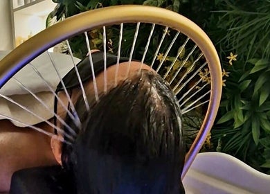 Relaxing head spa treatment at Hairmonic Head Spa, London, England, GB with soothing water jets for hair rejuvenation.