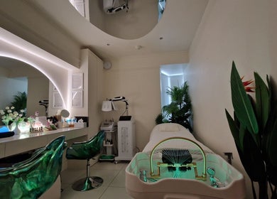 Relaxing treatment room at Hairmonic Head Spa London, located in London, England, GB, with lush greenery and chic decor.