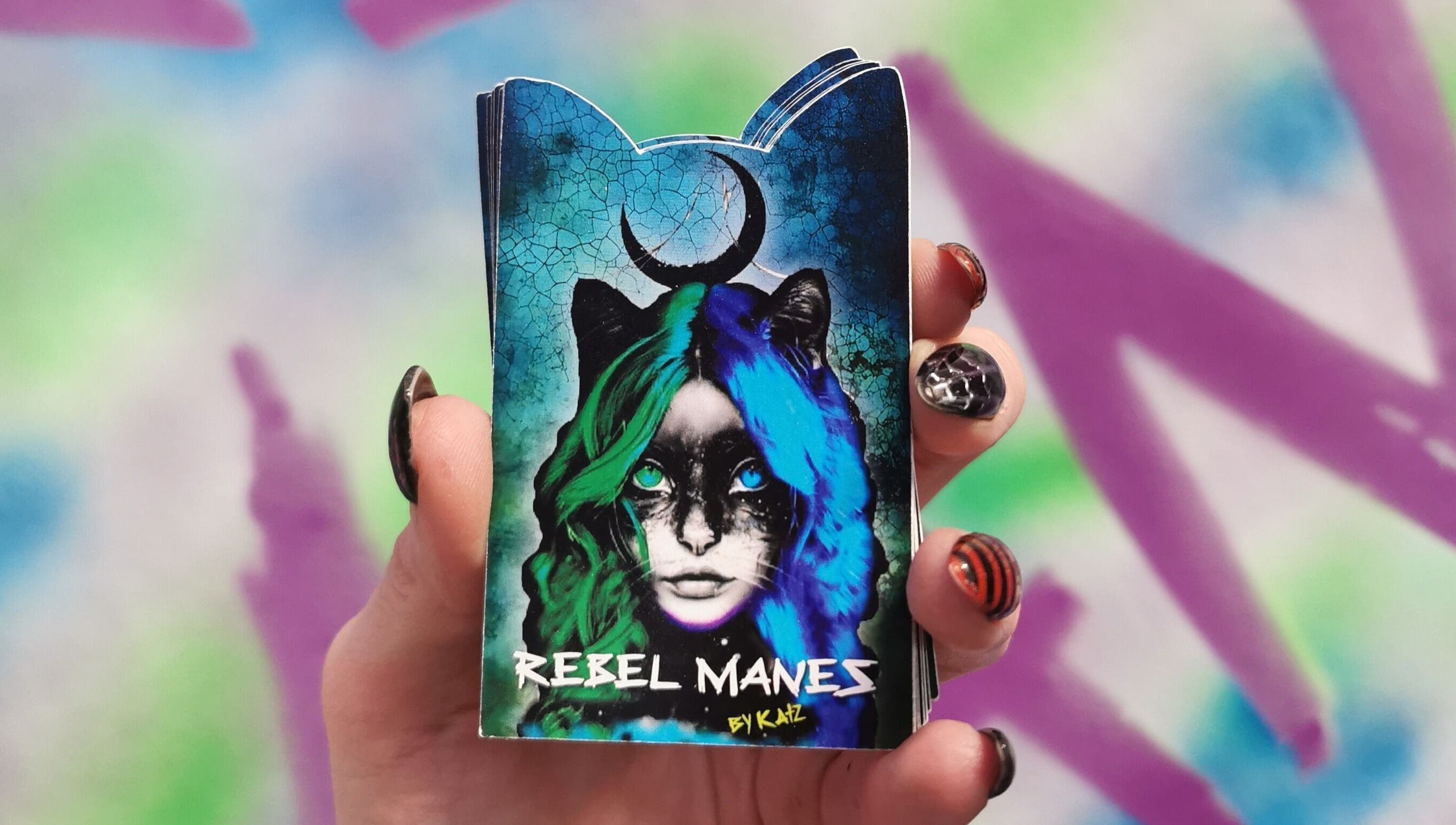 Colorful artistic card held in hand at Rebel Manes, Drogheda, County Louth, IE.