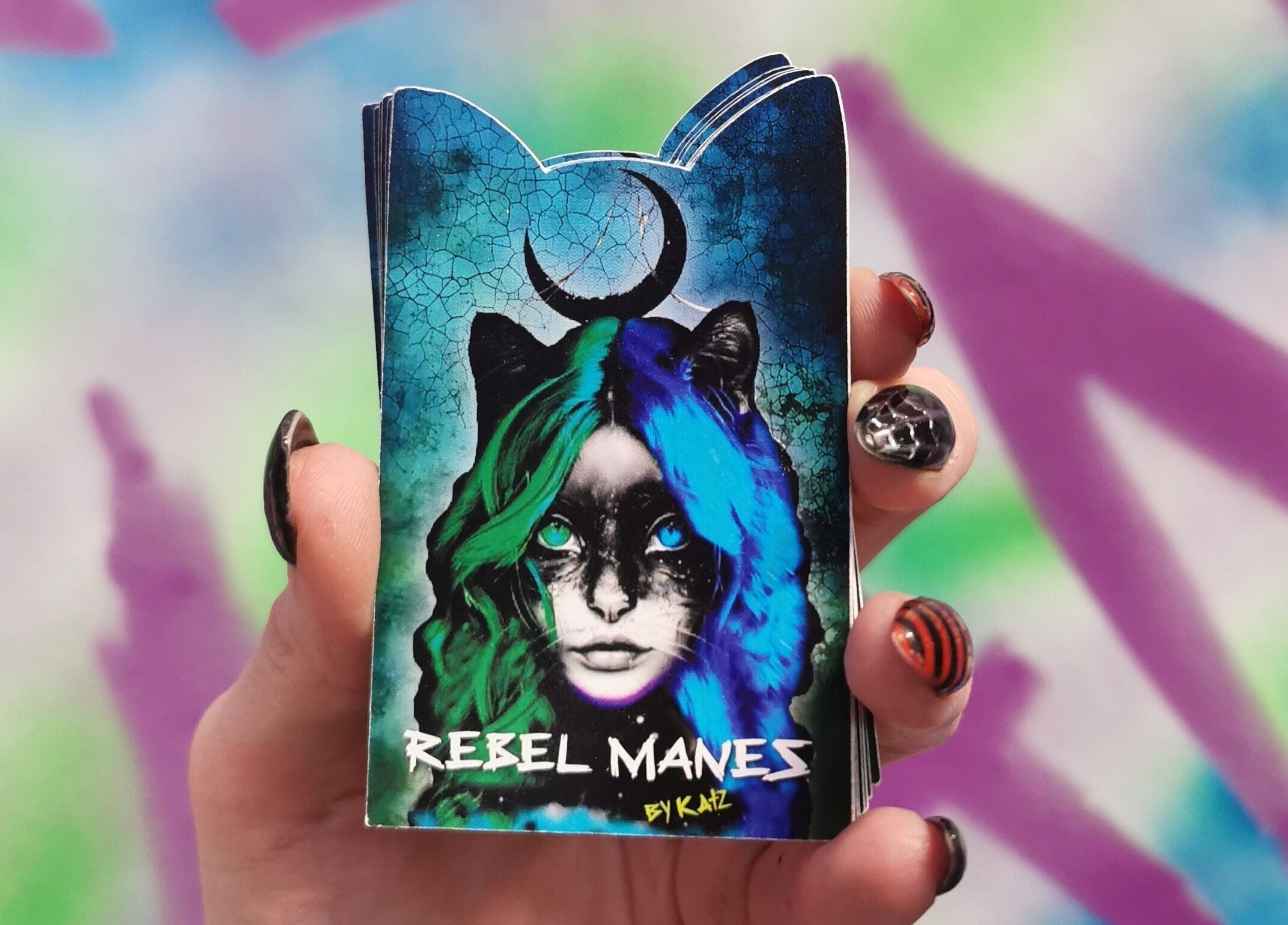 Colorful artistic card held in hand at Rebel Manes, Drogheda, County Louth, IE.