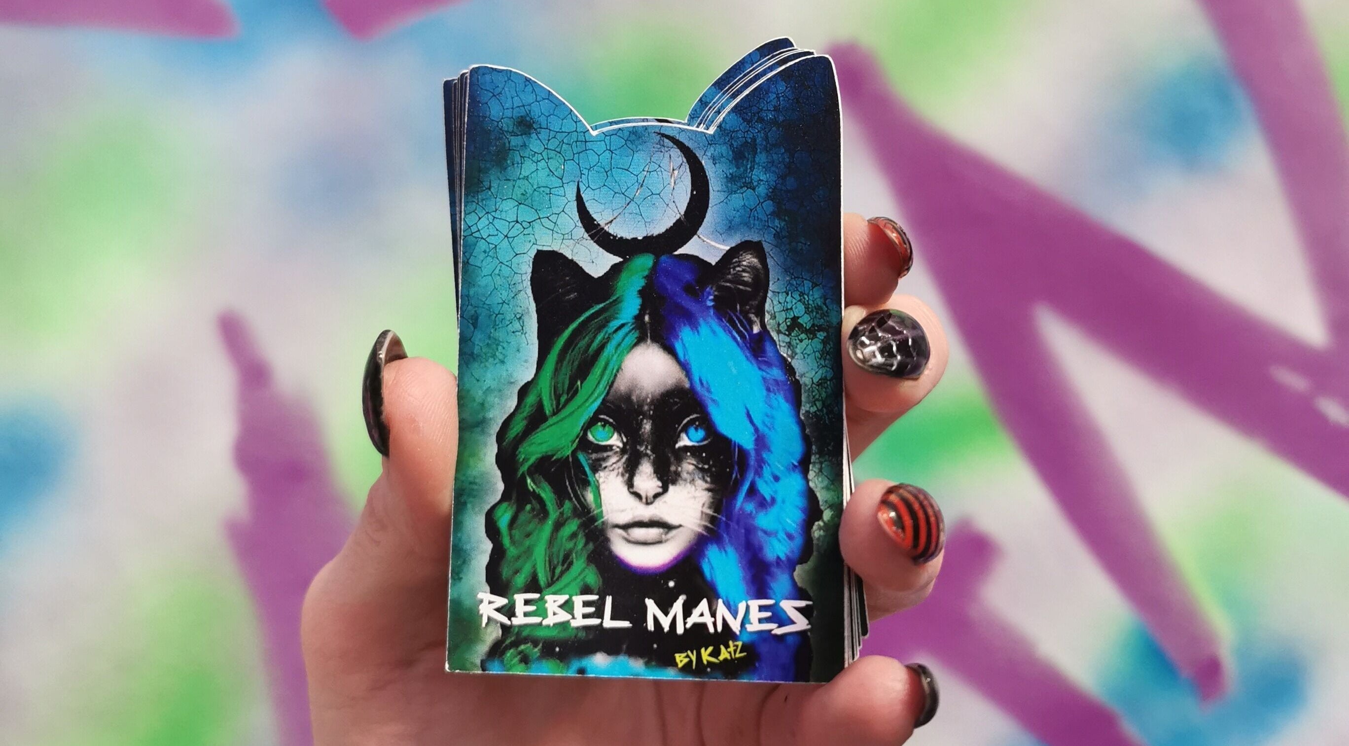 Colorful artistic card held in hand at Rebel Manes, Drogheda, County Louth, IE.