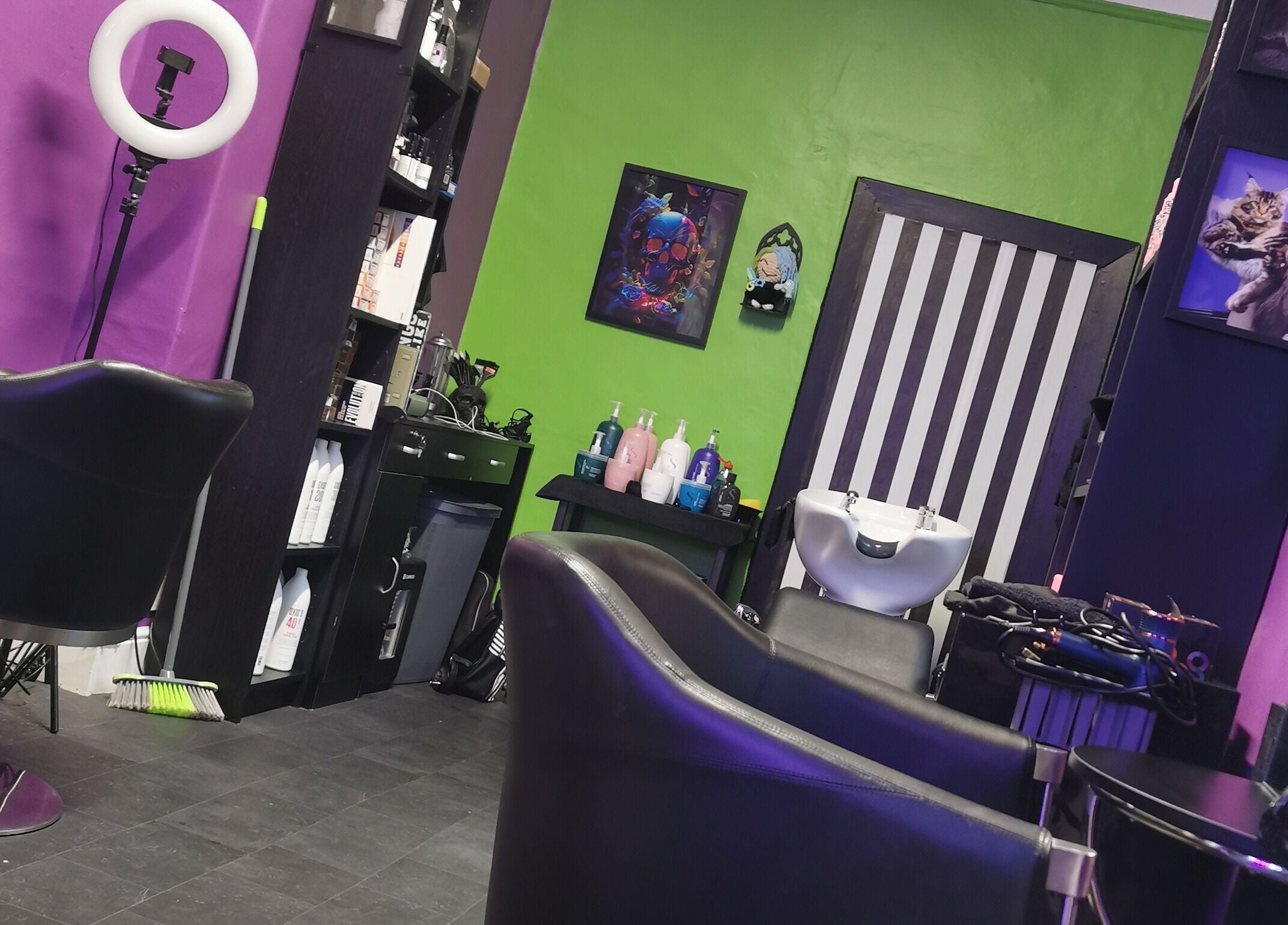 Bold interior of Rebel Manes salon in Drogheda, County Louth, IE featuring bright walls and styling chairs.