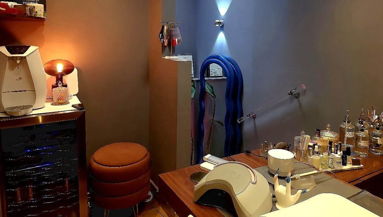Interior of Crazylong Nail Studio in London, England, GB, showcasing cozy seating and manicure tools.