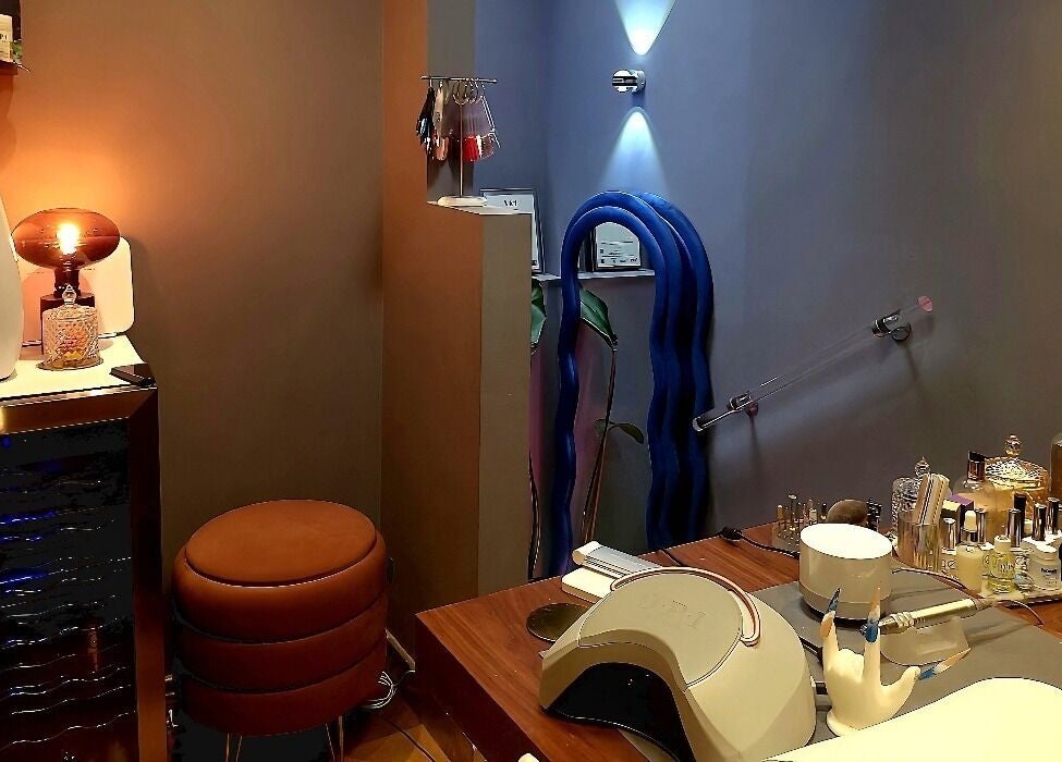 Interior of Crazylong Nail Studio in London, England, GB, showcasing cozy seating and manicure tools.
