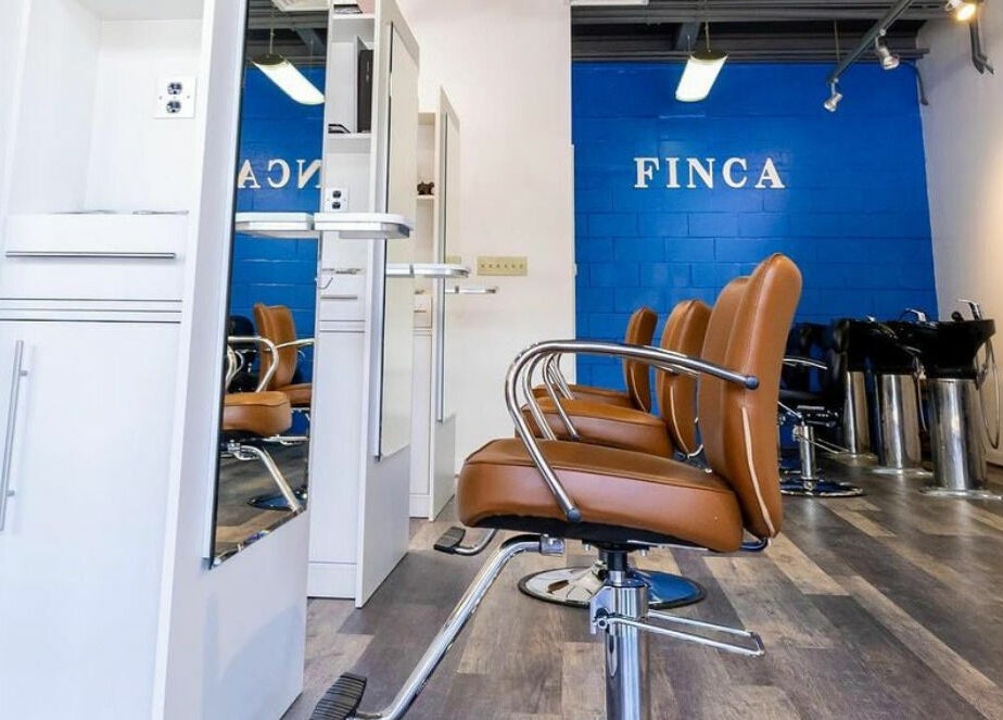 Modern salon interior at Finca Beauty Salon - Aina Haina, Honolulu, Hawaii, US with sleek chairs and stations.