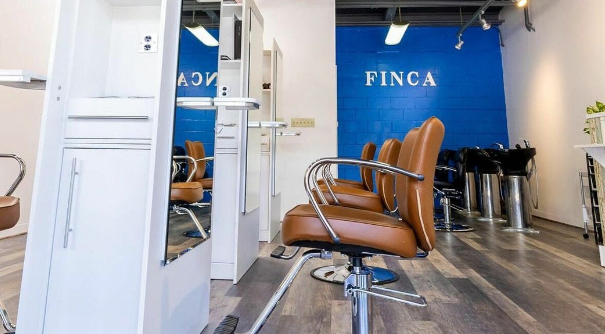 Modern salon interior at Finca Beauty Salon - Aina Haina, Honolulu, Hawaii, US with sleek chairs and stations.
