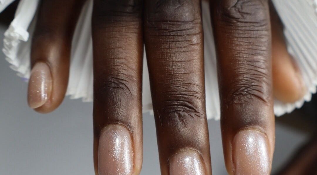 Close-up of polished nails at æló beauty, Sola, Rogaland, NO showcasing glossy finish.