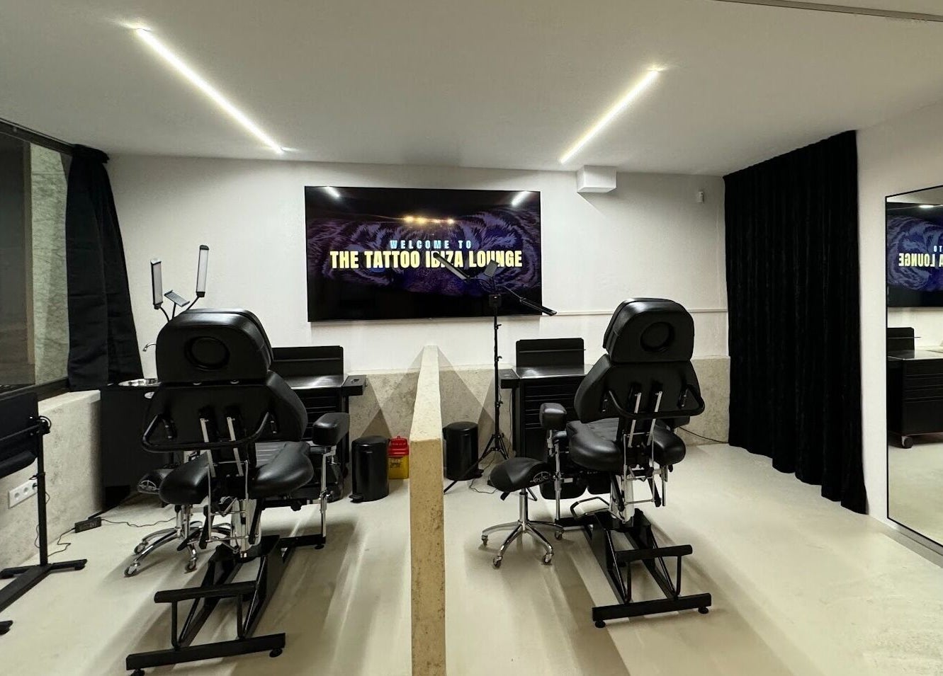 Modern tattoo studio at Tattoo Ibiza Lounge, Eivissa, Illes Balears, ES, featuring sleek chairs and equipment.