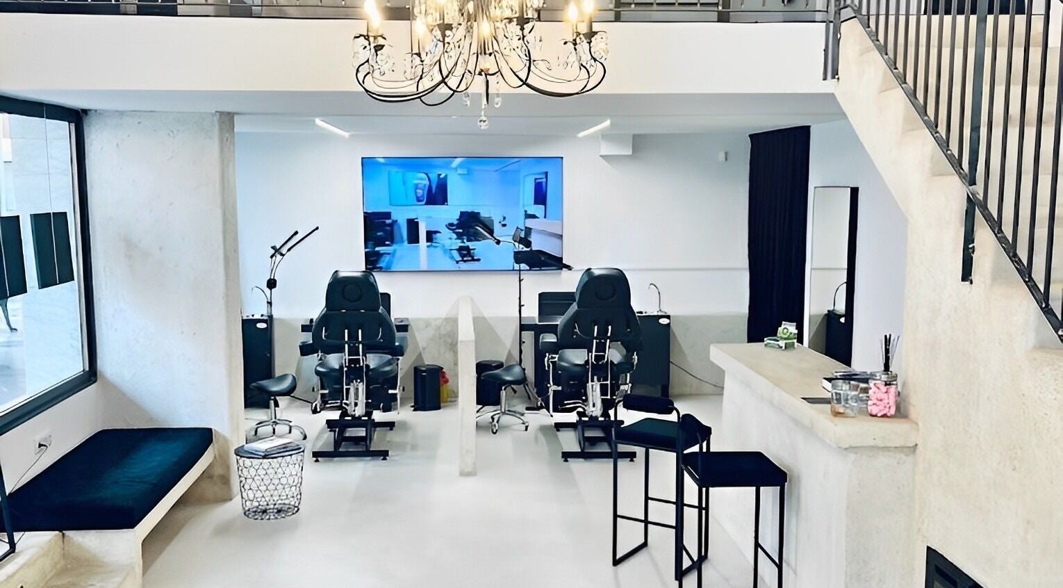 Modern interior of Tattoo Ibiza Lounge, Eivissa, Illes Balears, ES, featuring tattoo chairs and elegant decor.