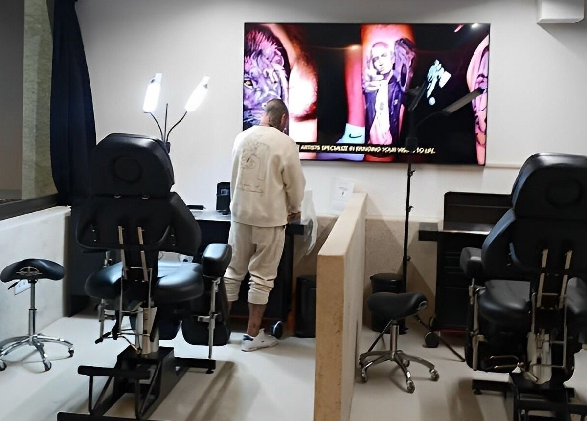 Interior view of Tattoo Ibiza Lounge in Eivissa, Illes Balears, ES, showcasing tattoo chairs and vibrant artwork.