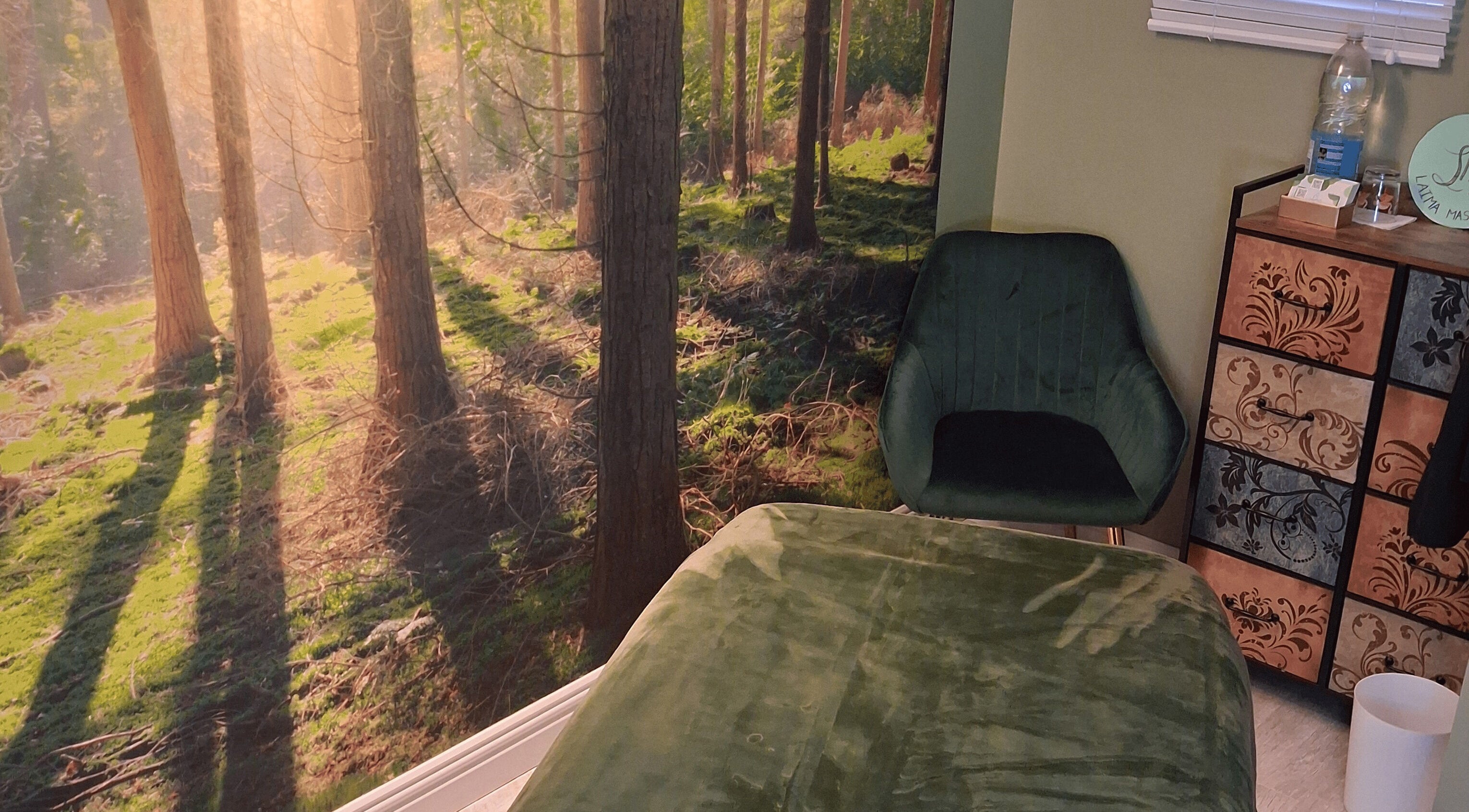 Tranquil massage room with forest mural at Laima Massage, Bletchley, England, GB, offering a calming ambiance.