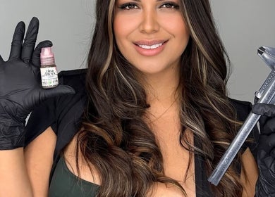 Aesthetician at Studio Constanza F in Hollywood, Florida, US holding beauty tools, smiling confidently.