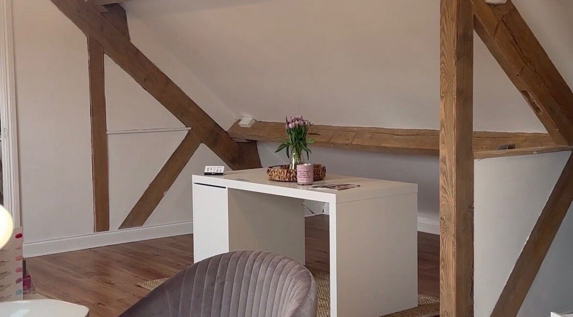 Stylish loft space at JL’s Hideaway Beauty & Aesthetics, Bewdley, England, GB featuring a modern desk and beams.