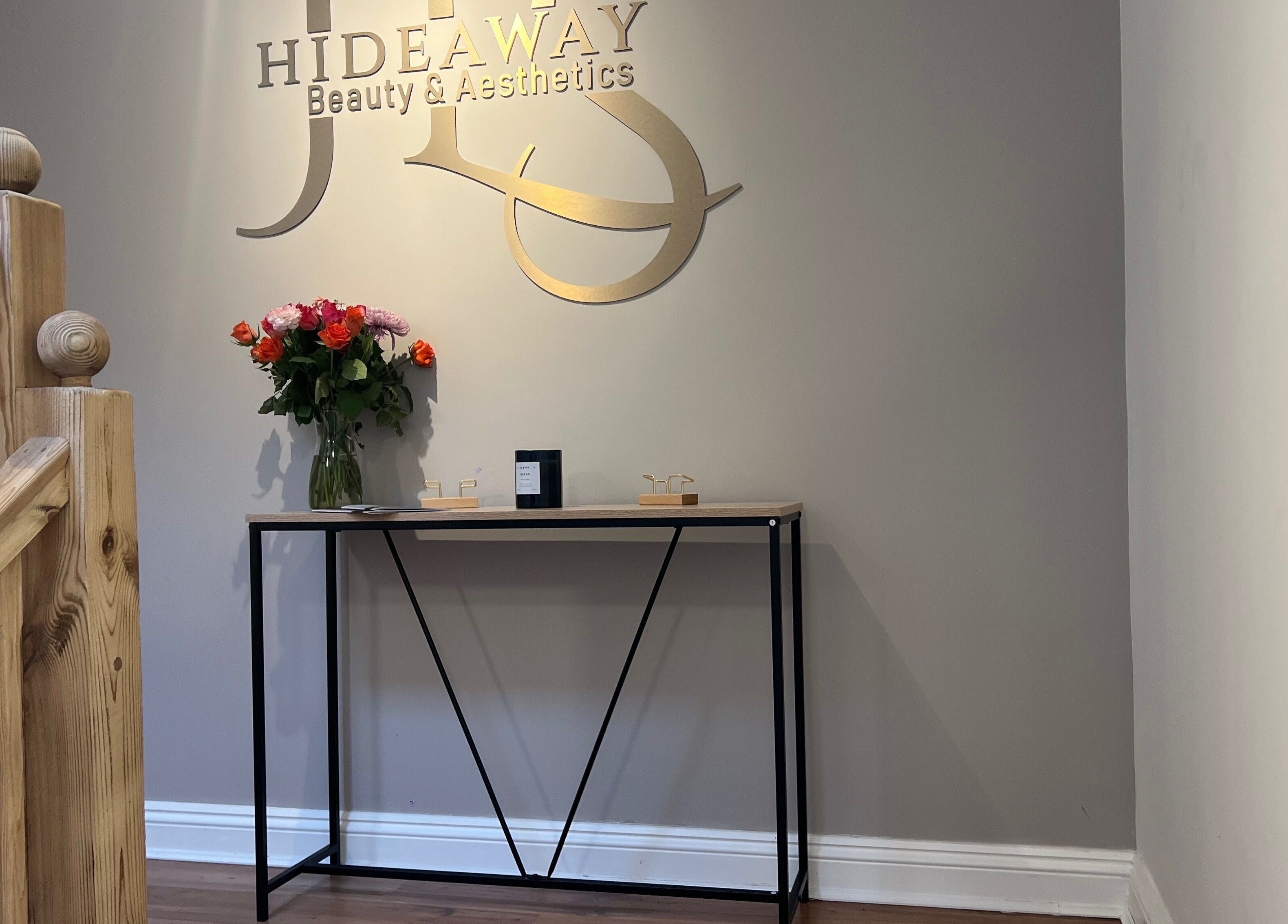 Elegant entryway at JL’s Hideaway Beauty & Aesthetics, Bewdley, England, with flower decor.