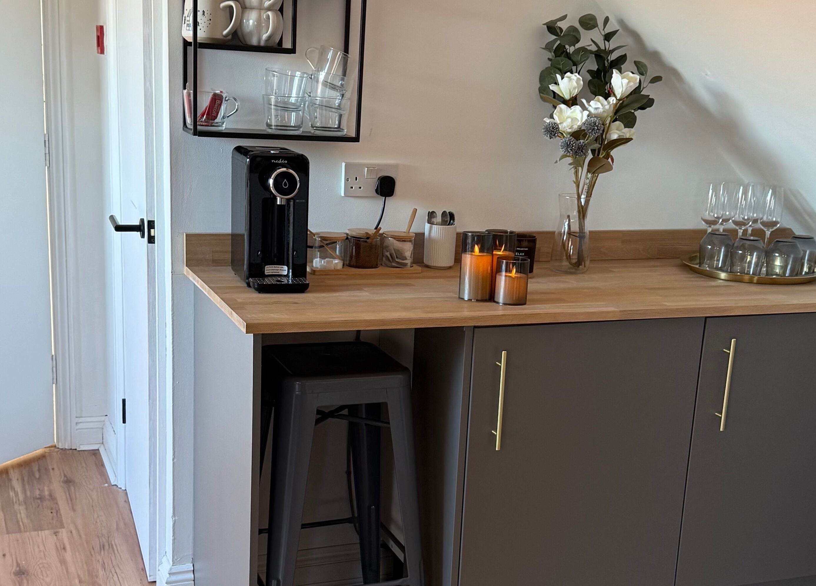 A stylish coffee nook at JL’s Hideaway Beauty & Aesthetics, Bewdley, England, GB, featuring a coffee machine and decor.