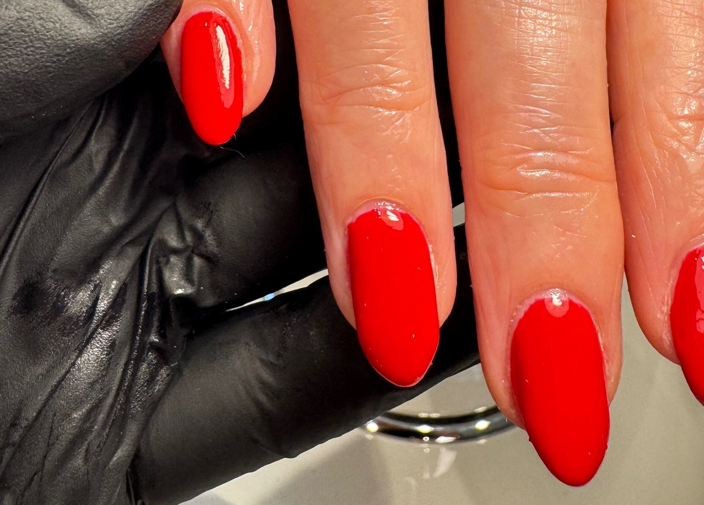 Vibrant red manicured nails at The Wellness Hub, Blackburn, England, GB.