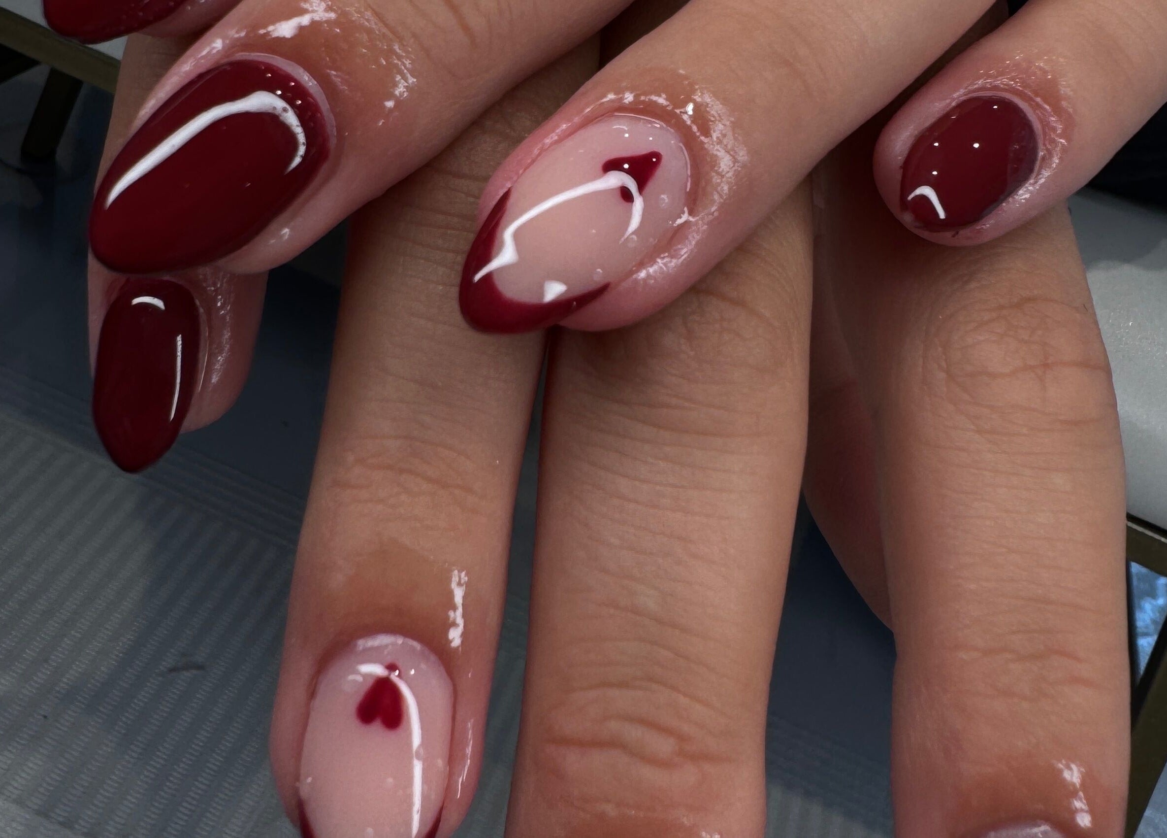 Stylish red and nude nail art at The Wellness Hub, Blackburn, England, GB, showcasing exquisite design.