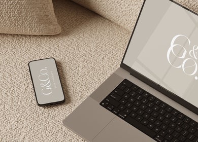Laptop and phone with G&Co. logo at cozy venue in Liverpool, England, GB.