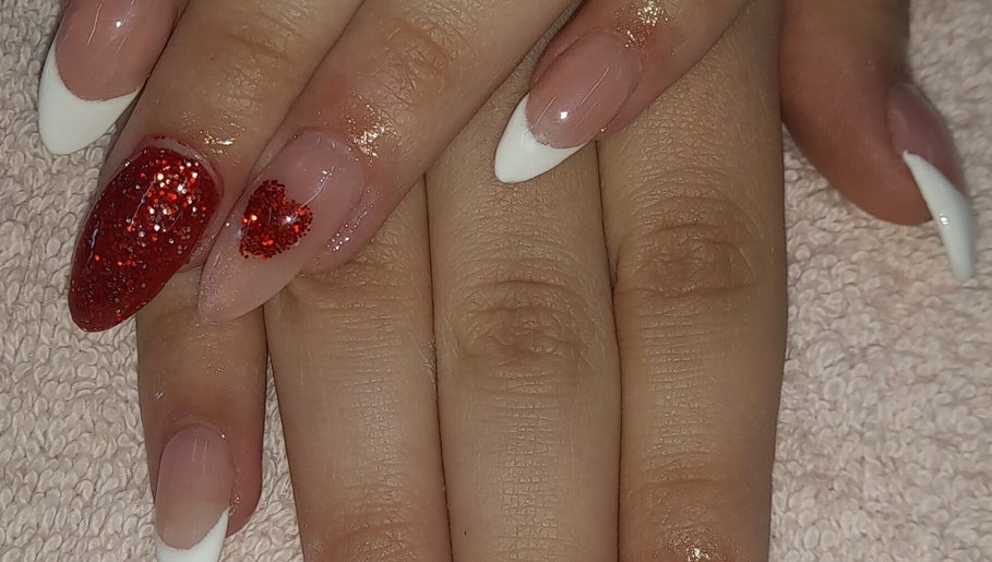 Stylish red glitter nail art at NATASHA'S NAILS in Kempton Park, Gauteng, ZA, showcasing expert nail design.