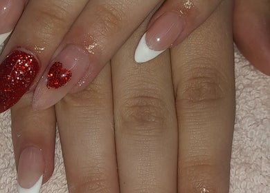 Stylish red glitter nail art at NATASHA'S NAILS in Kempton Park, Gauteng, ZA, showcasing expert nail design.