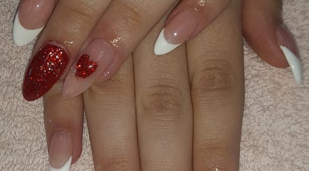Stylish red glitter nail art at NATASHA'S NAILS in Kempton Park, Gauteng, ZA, showcasing expert nail design.