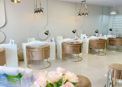 Chic interior of Elle Nail Couture in Boksburg, Gauteng, ZA featuring velvet chairs and modern nail stations.