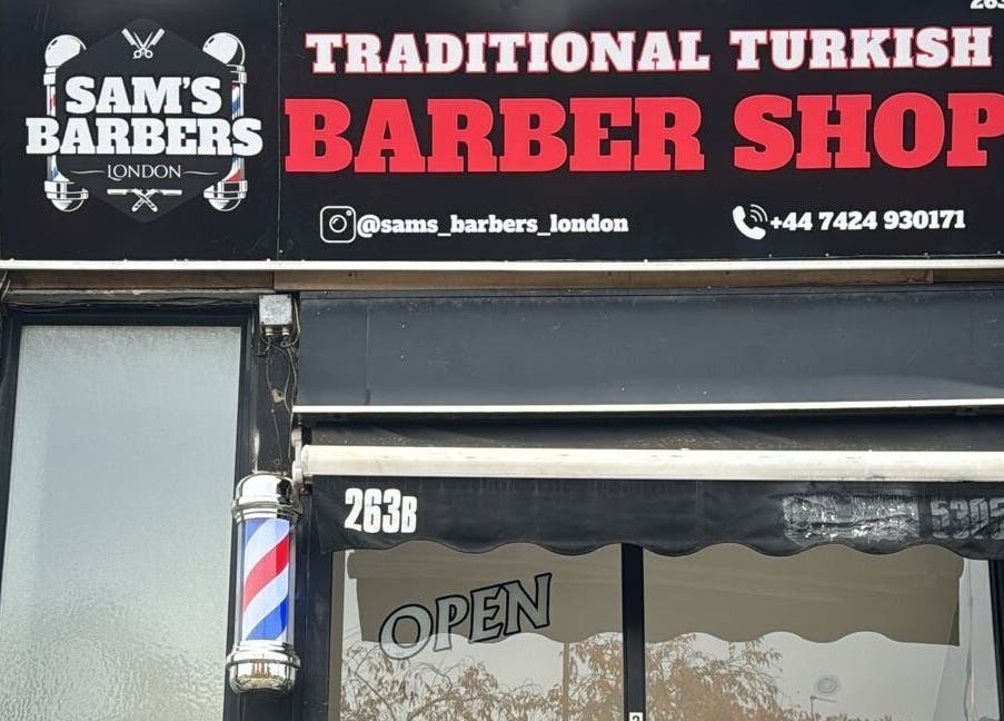 Exterior of Sam’s Barbers London located in London, England, GB, showcasing a traditional Turkish barber shop sign.