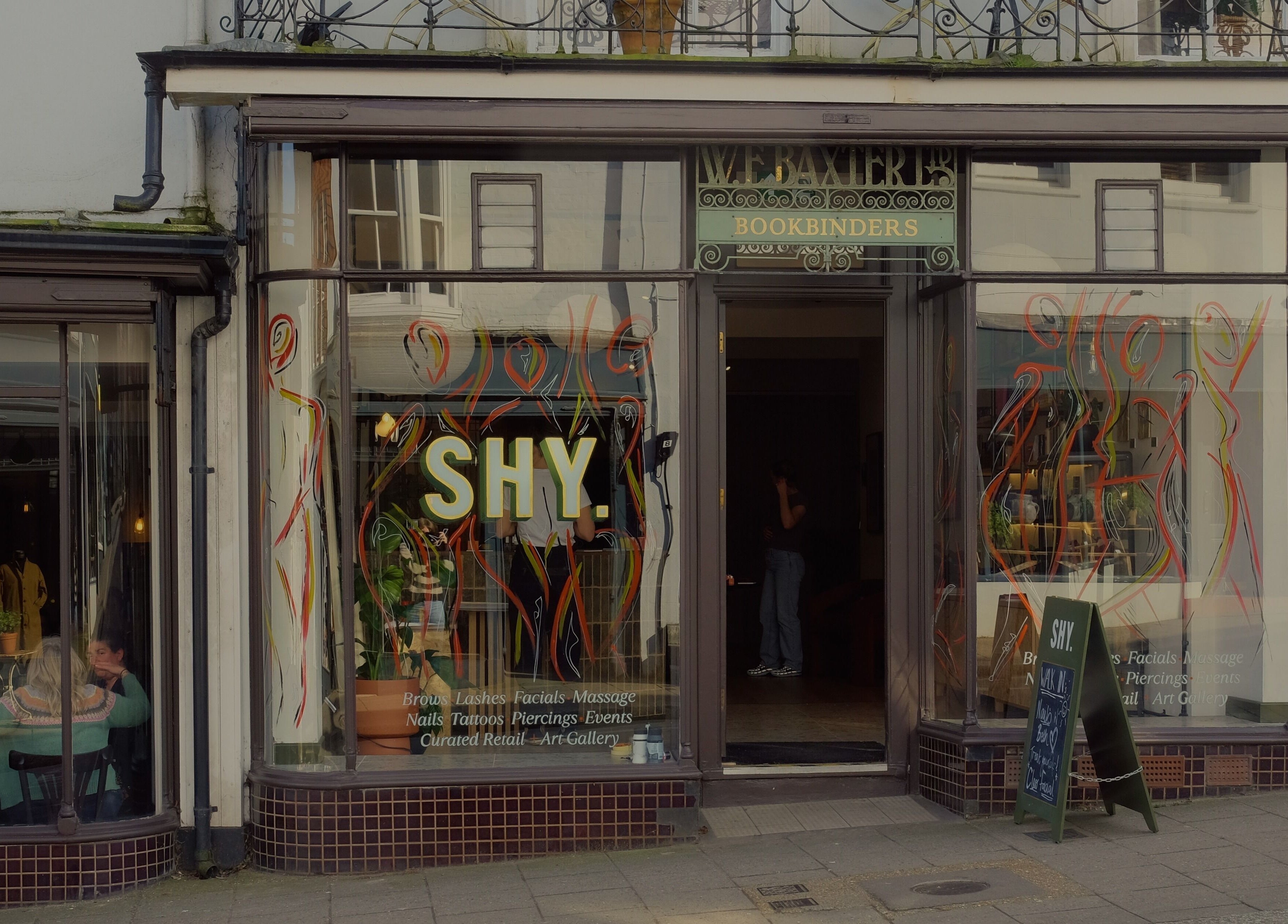 Front view of Cleo Rogers Skincare - SHY Studios in Lewes, England, showcasing vibrant window designs.