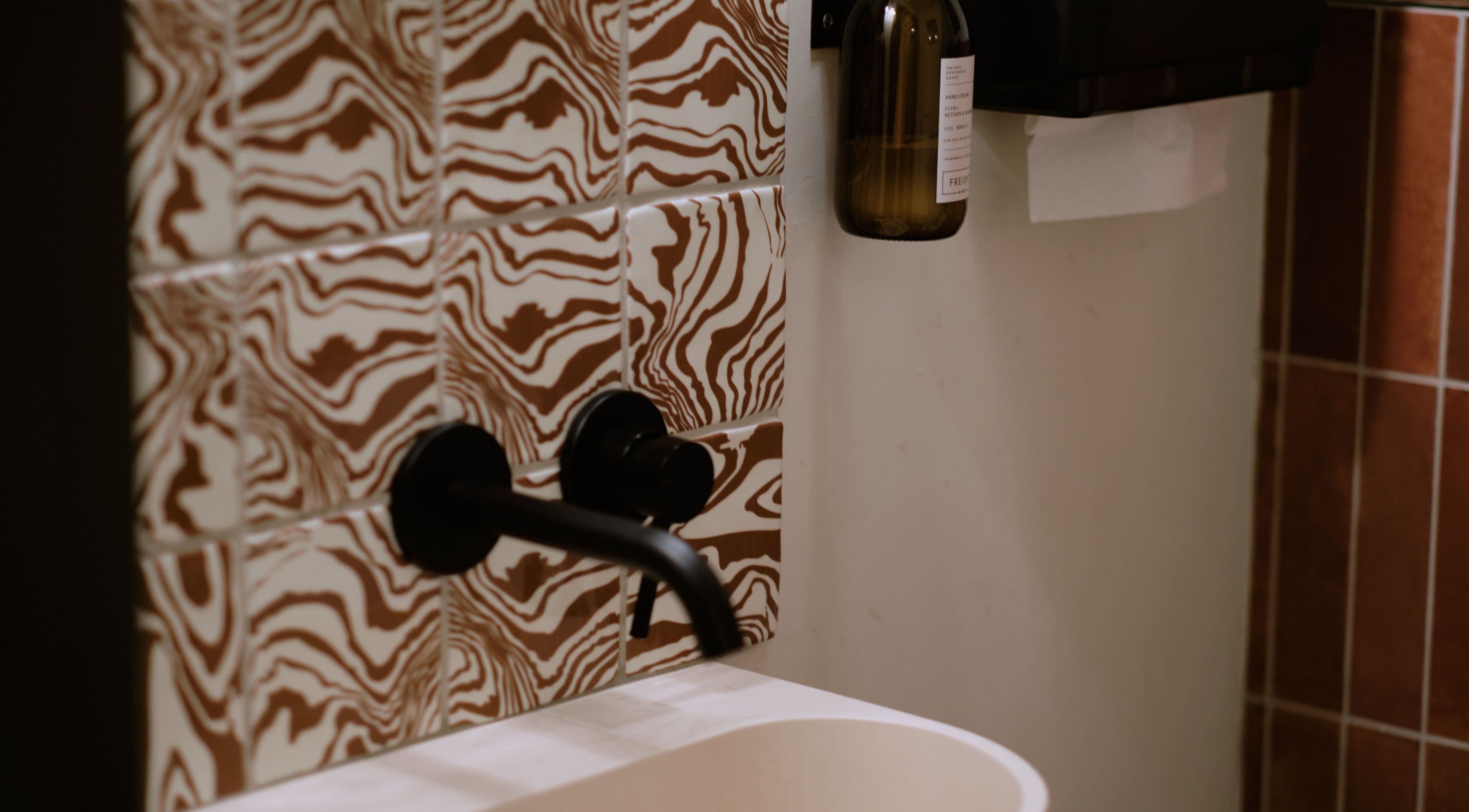 Artistic bathroom tiles and faucet at Cleo Rogers Skincare - SHY Studios in Lewes, England, GB.