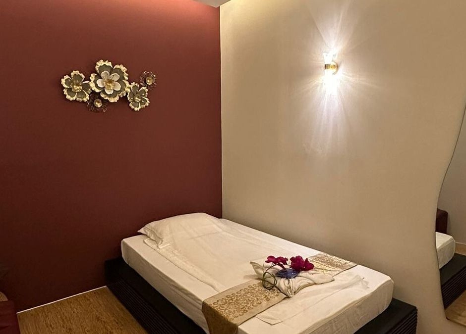 Serene massage room at Lotus Spa & Retreat, Dubai, featuring elegant decor and ambient lighting for relaxation.