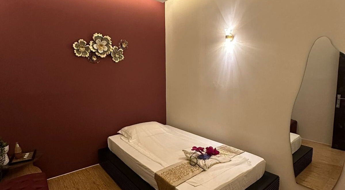 Serene massage room at Lotus Spa & Retreat, Dubai, featuring elegant decor and ambient lighting for relaxation.